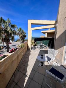 patio z krzesłami i stołem w budynku w obiekcie GATU Villa Atardecer en la playa de las Redes " Preferente mayores de 21 años y familias " w mieście El Puerto de Santa María