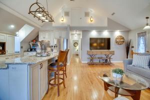 a kitchen and living room with a couch and a table at Cozy Virginia Vacation Rental with Seasonal Pool! in Nokesville