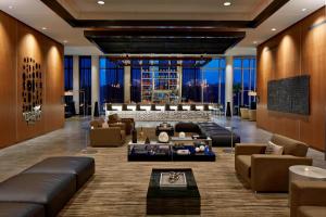 a lobby with leather couches and a bar at AC Hotel Columbus Dublin in Dublin