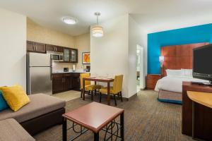 a hotel room with a bed and a living room at Residence Inn Chattanooga Downtown in Chattanooga