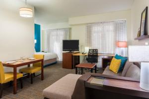 um quarto de hotel com uma cama e uma sala de estar em Residence Inn Chattanooga Downtown em Chattanooga