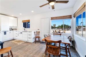 a kitchen and dining room with a table and chairs at Cozy Fresh Desert Hideaway, 5 mins to Joshua Tree in Twentynine Palms