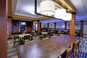 a large dining room with a large wooden table and chairs at Fairfield Inn & Suites by Marriott Wausau in Weston