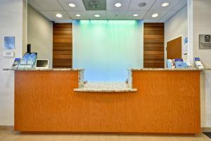 a lobby with two reception desks and a glass wall at Fairfield Inn & Suites by Marriott Atlanta Vinings/Galleria in Atlanta