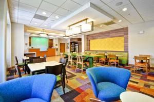 a dining room with tables and chairs and a chalkboard at Fairfield Inn & Suites by Marriott Atlanta Vinings/Galleria in Atlanta