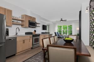 a kitchen and dining room with a table and chairs at Marriott's Fairway Villas in Galloway