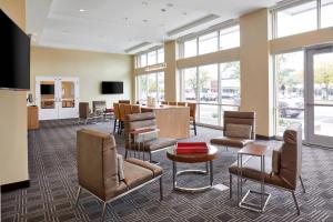 a waiting room with chairs and a table at TownePlace Suites by Marriott Columbus North - OSU in Columbus
