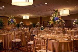 a banquet hall with tables and chairs with flowers at The Inn at Opryland, A Gaylord Hotel in Nashville