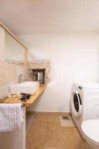 a bathroom with a sink and a toilet at Holiday Home Oliti with Pool in Mošćenice