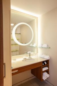 a bathroom with a sink and a large mirror at SpringHill Suites Wenatchee in Wenatchee