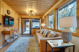 a living room with a couch and a table at Leavenworth Cabin with Private Hot Tub! in Leavenworth