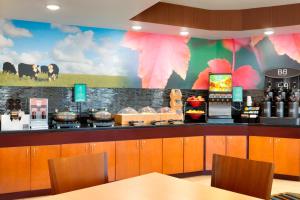 a restaurant with a counter with food on it at Fairfield Inn & Suites Fort Worth University Drive in Fort Worth