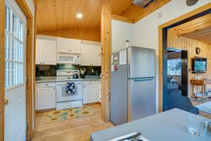 a kitchen with white cabinets and a refrigerator at Leavenworth Cabin with Private Hot Tub! in Leavenworth