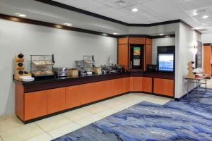 a large kitchen with a counter in a restaurant at Fairfield Inn & Suites Indianapolis Avon in Avon