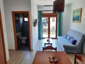 a living room with a couch and a table at Olga's appartments in Ouranoupoli