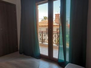 a room with a window with a view of a balcony at Olga's appartments in Ouranoupoli