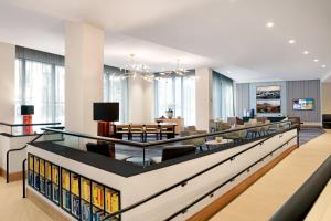 a library with bookshelves and a dining room at Courtyard Boston Downtown/North Station in Boston