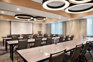 a conference room with tables and chairs and a projection screen at Courtyard Boston Downtown/North Station in Boston