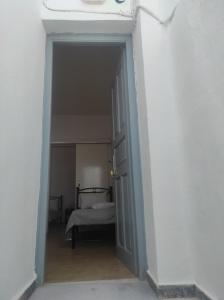 an open doorway to a bedroom with a bed at Mama's House in Ios Chora