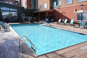 a large swimming pool with chairs and a building at Residence Inn by Marriott Houston Pasadena in Pasadena
