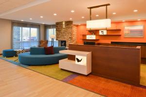 a hotel lobby with a couch and a table at Fairfield Inn & Suites by Marriott Martinsburg in Martinsburg