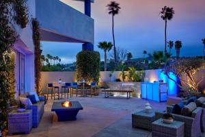 a patio with couches and a table and chairs at Ventura Beach Marriott in Ventura