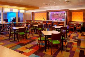 a restaurant with tables and chairs and a bar at Fairfield Inn & Suites by Marriott Springfield Northampton/Amherst in Northampton