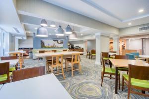 an image of a dining room with tables and chairs at Fairfield Inn & Suites Raleigh Crabtree Valley in Raleigh