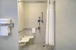a bathroom with a shower with a shower curtain at Fairfield Inn & Suites by Marriott Atlanta Kennesaw in Kennesaw +29 photos