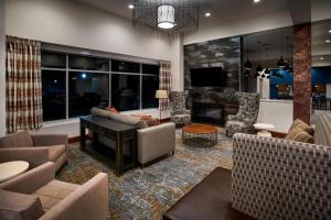 a living room with a couch and a piano at Residence Inn by Marriott Wilmington Downtown in Wilmington