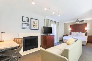 a hotel room with a bed and a living room at Residence Inn by Marriott Atlanta Cumberland/Galleria in Atlanta