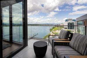 a balcony with a couch and a view of the water at AC Hotel by Marriott Vancouver Waterfront in Vancouver