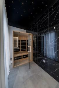 a bathroom with black marble walls and a window at Bounce in Belgrade