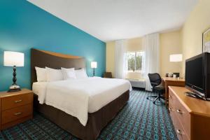 a hotel room with a bed and a desk and a television at Fairfield Inn Kankakee Bourbonnais in Bourbonnais