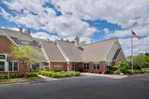 a building with an american flag in front of it at Residence Inn by Marriott Detroit / Novi in Novi