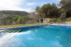 a large swimming pool with blue water at Cottage Eco-Friendly Barcelona country side in La Garriga