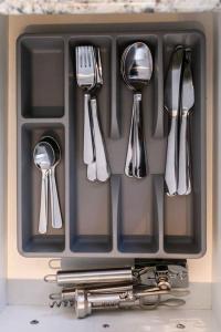a tray of utensils in a drawer on a counter at Modern Beach Oasis in San Diego