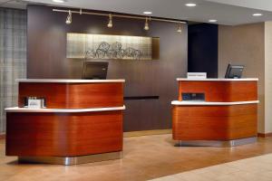 a lobby with two reception desks in a building at Courtyard by Marriott Fayetteville in Fayetteville