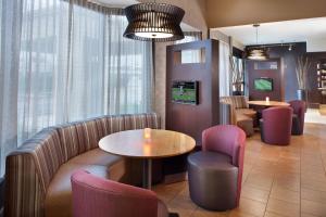 a waiting room with a table and chairs at Courtyard by Marriott Fayetteville in Fayetteville