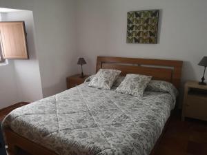 a bedroom with a large bed with two pillows at Casa rural Ardetxal a 16km de Logroño y Laguardia in Viñaspre