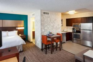 a large hotel room with a bed and a kitchen at Residence Inn by Marriott Las Vegas Henderson/Green Valley in Las Vegas