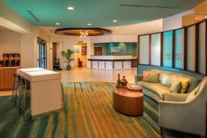 a living room with a couch and a table at SpringHill Suites by Marriott Charlotte Airport in Charlotte