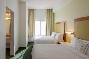 a hotel room with two beds and a window at SpringHill Suites by Marriott Charlotte Airport in Charlotte