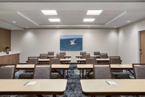 an empty lecture room with tables and chairs at Fairfield by Marriott Inn & Suites Bonita Springs in Bonita Springs