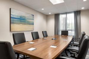 a conference room with a wooden table and chairs at Fairfield by Marriott Inn & Suites Bonita Springs in Bonita Springs