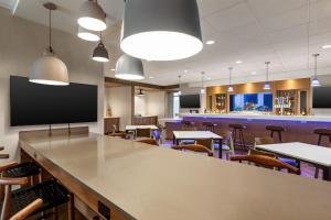 a large room with tables and chairs and a tv at Fairfield by Marriott Inn & Suites Bonita Springs in Bonita Springs