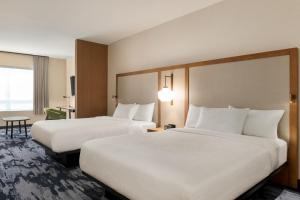 two beds in a hotel room with white sheets at Fairfield by Marriott Inn & Suites Bonita Springs in Bonita Springs