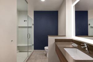 a bathroom with a toilet and a glass shower at Fairfield by Marriott Inn & Suites Bonita Springs in Bonita Springs