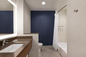 a bathroom with a toilet and a sink and a shower at Fairfield by Marriott Inn & Suites Bonita Springs in Bonita Springs