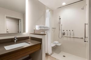 a bathroom with a sink and a shower at Fairfield by Marriott Inn & Suites Bonita Springs in Bonita Springs